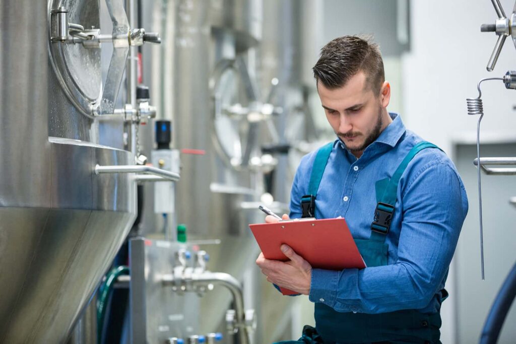 image of a man in overalls performing checks on a system
