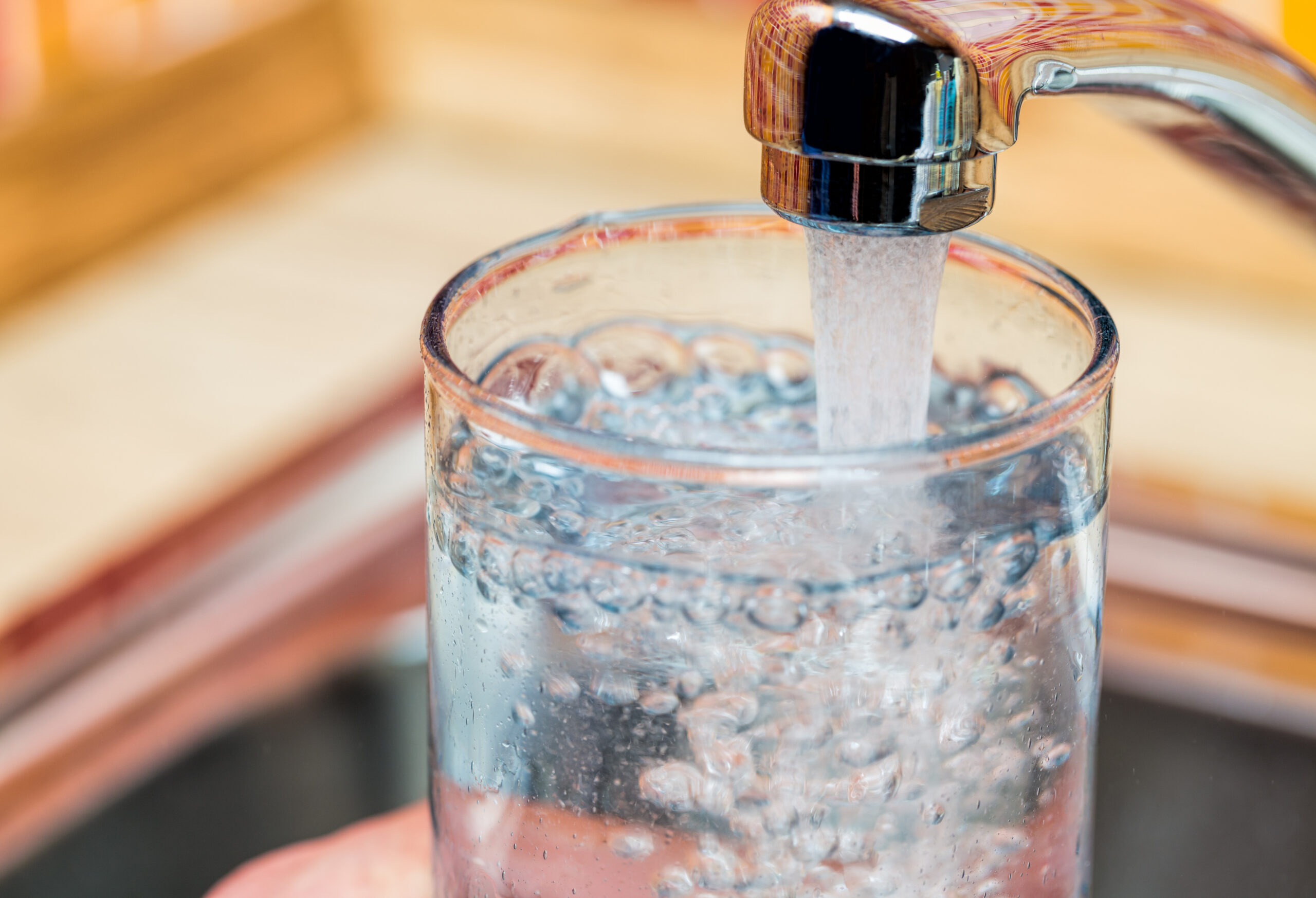 tap water filling up a glass