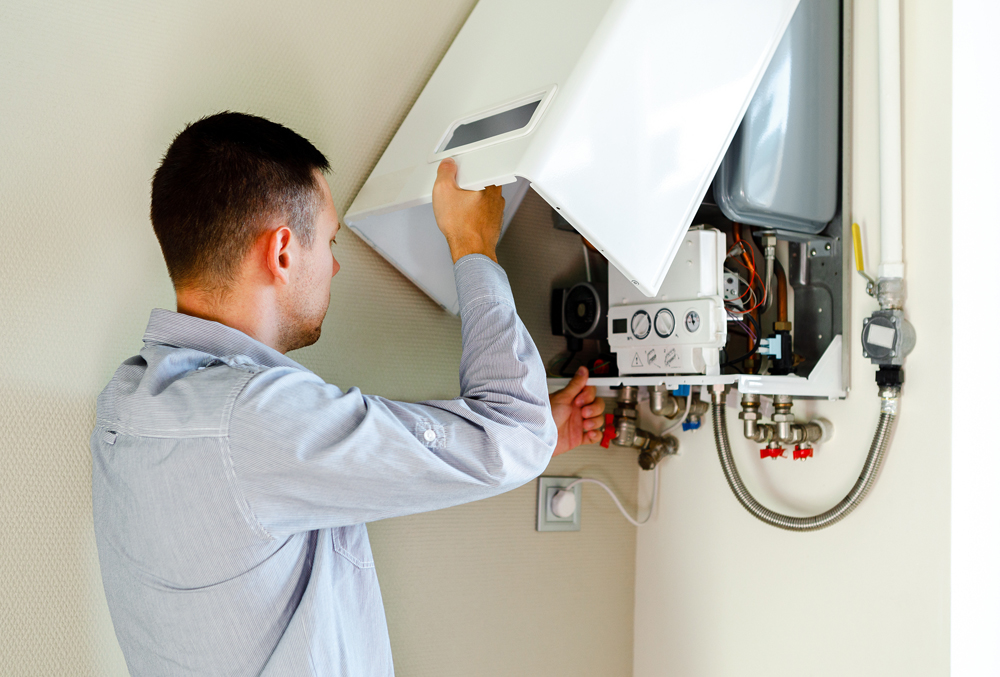 Service technician performing maintenance for tankless water heater