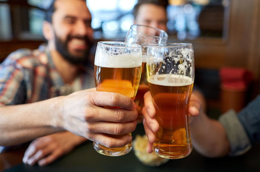 group of people toasting beer at restaurant