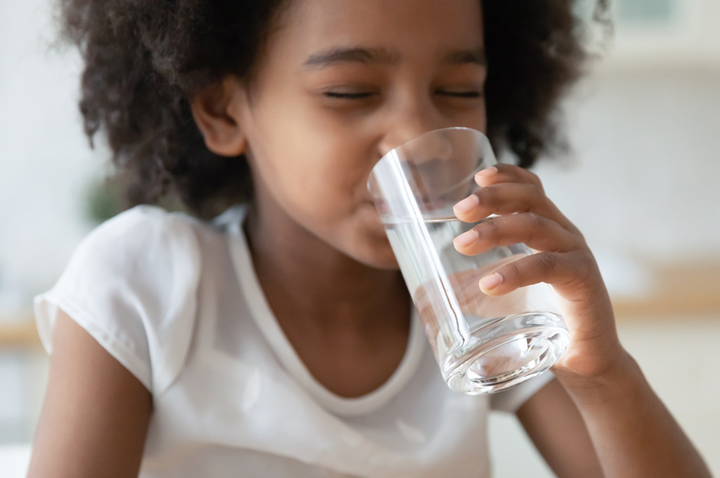 girl drinking water from a glass